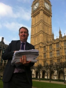 Pictured: Nigel Mills MP standing outside Parliament, ready to hand in over 3,000 petitions to reopen Heanor Memorial Hospital